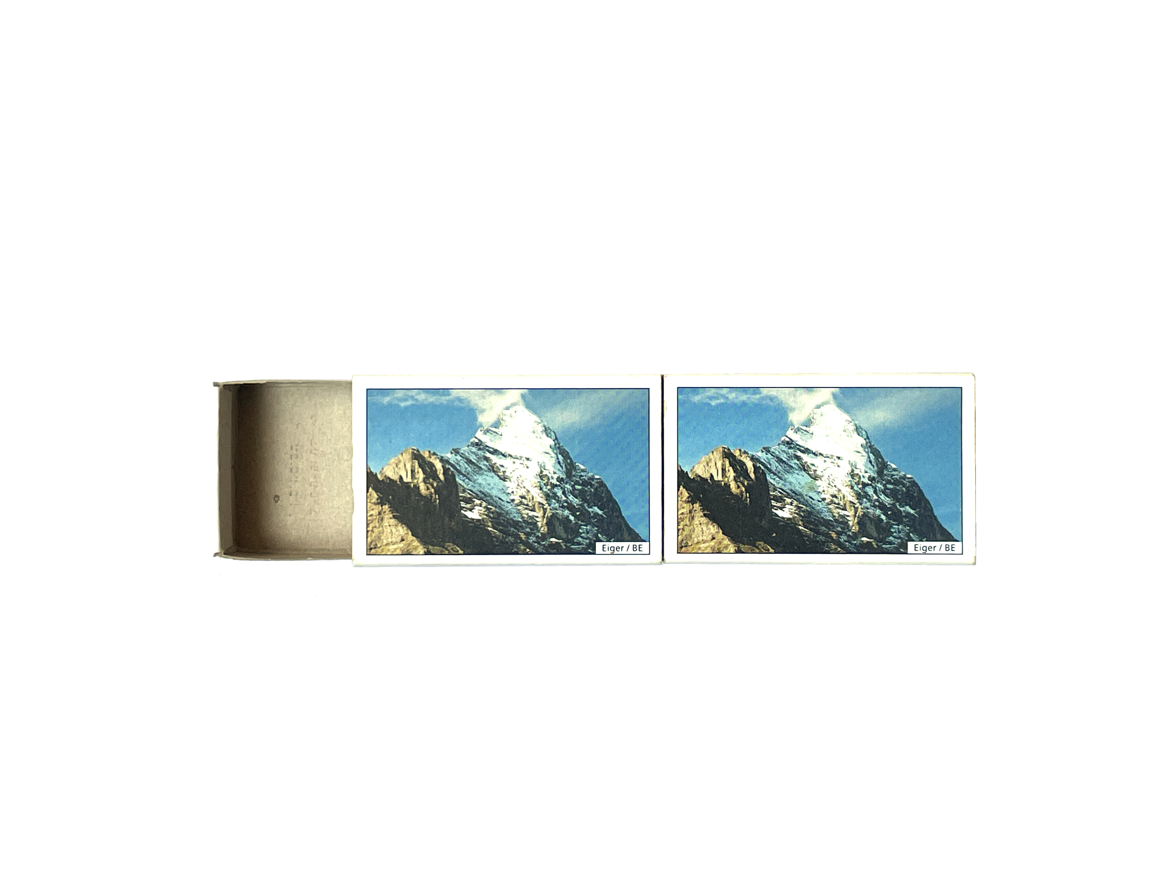 photo of two matchboxes with an image of a snow-capped mountain peak with the text "Eiger / BE" in the bottom right corners