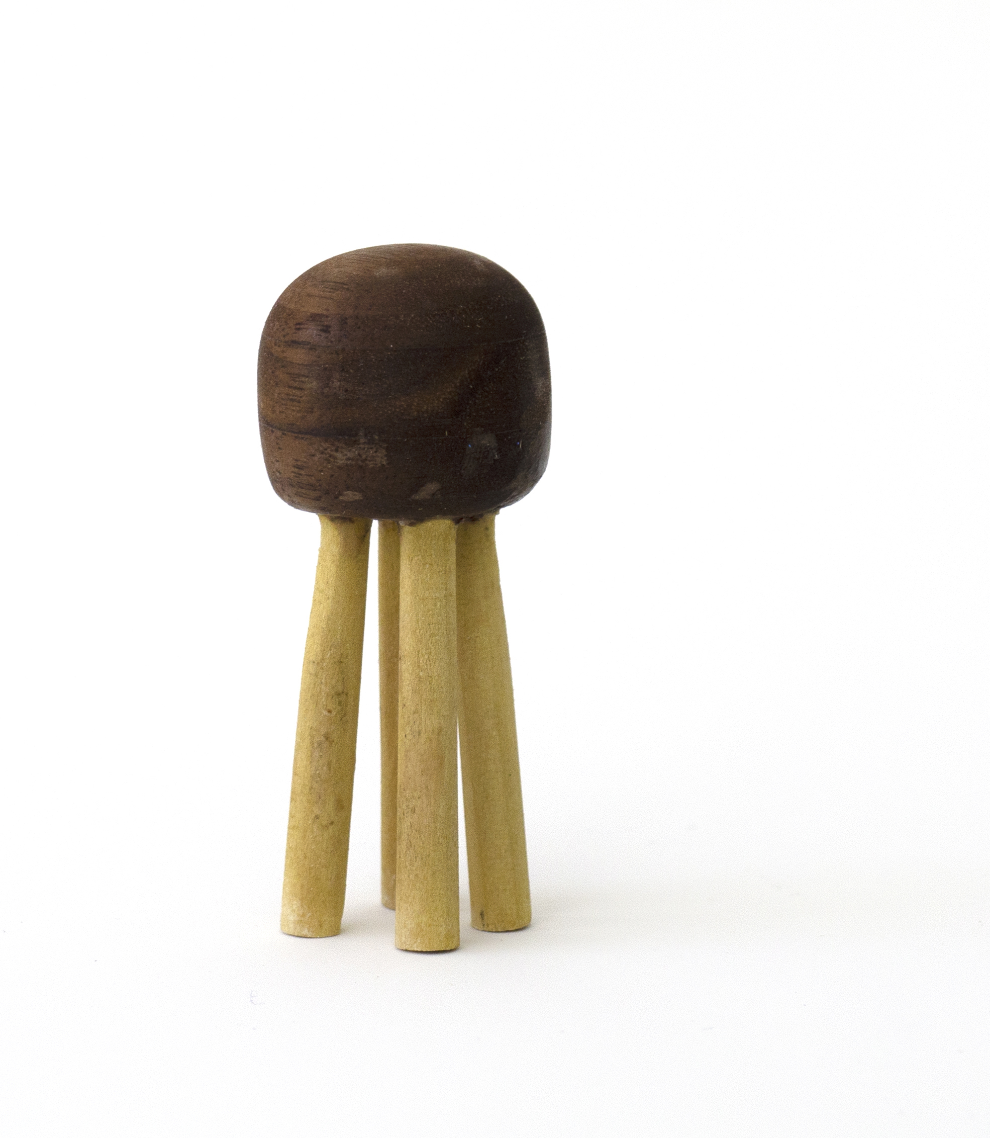 small wooden mini-stool with four light wood legs and a dark wood rounded top